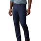 A man stands against a plain background wearing a light blue checkered shirt, brown shoes, and Faherty’s Movement Linen 5-Pocket Pant in navy blue.