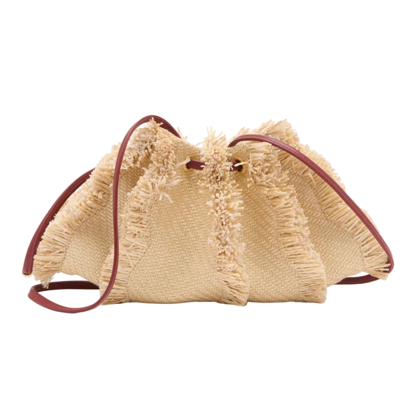 The Adria Small Crossbody by Ulla Johnson is a woven beige straw raffia handbag with frayed edges, brown leather straps, and a removable shoulder strap, shown on a white background.