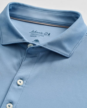 Light blue Johnnie-O Birdie Polo in size medium, shown folded with three buttons fastened and collar neatly arranged. Crafted from lightweight, moisture-wicking fabric with UPF 50 protection for all-day comfort and style.