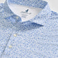 The Marietta Polo by Johnnie-O features a light blue hue with a small dark blue floral pattern, accented by white buttons and a branded label inside the collar. Crafted in a modern featherweight design, this polo delivers comfort and subtle sophistication—perfect for warm days at the office or enjoying sun protection outdoors.
