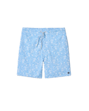 The Johnnie-O Swingin Swim Trunks, featuring a light blue fabric with a playful white floral print, white drawstring, and a small round black and white logo patch on the lower left leg, are stylish surf shorts shown on a white background.