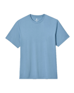 The Tee by Johnnie-O, a light blue short-sleeve crew neck shirt with a sand-washed finish, is shown laid flat on a white background for a relaxed, casual look.