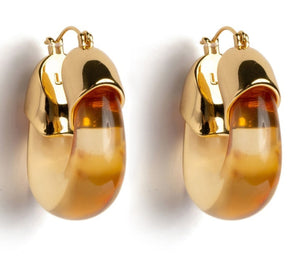 The Organic Gold Hoops by Lizzie Fortunato are glossy, gold and amber-toned resin earrings with a rounded, chunky design.