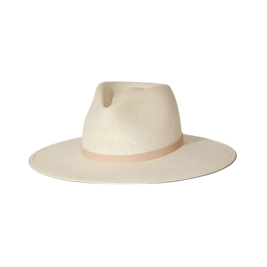 The Sherman Hat by Janessa Leone is a cream-colored, wide-brim packable straw fedora with a light beige band and timeless design, shown on a white background.