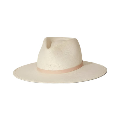 The Sherman Hat by Janessa Leone is a cream-colored, wide-brim packable straw fedora with a light beige band and timeless design, shown on a white background.