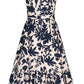 The Encanto Midi Dress by Andres Otalora is a sleeveless design with a bold white and blue print. It features a classic feminine silhouette with a fitted bodice, flared skirt, and navy floral pattern for an effortlessly chic knee-length look.