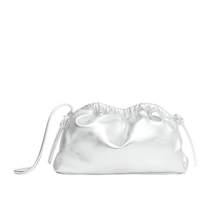 Mansur Gavriel's bestselling Mini Cloud Clutch is crafted from silver Italian lamb leather and features a ruched drawstring closure with a small loop handle against a white background. Customize it with a removable strap for versatile styling.