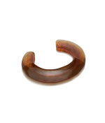 The Ridge Cuff by Lizzie Fortunato is a brown, translucent resin bracelet with a thick, open-ended design—ideal for stacking and bold style.