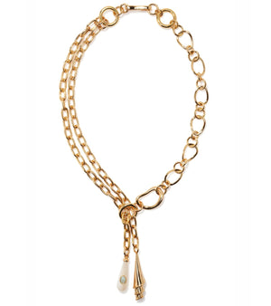 The Spiral Shell Necklace by Lizzie Fortunato features a gold-plated brass lariat design with mixed links and two pendants: a pointed gold charm and a teardrop-shaped charm accented with turquoise.