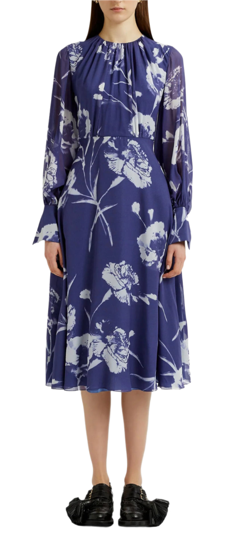 Someone wearing Erdem's Long Sleeve Midi Dress featuring a carnation print and gathered neckline, paired with flat black shoes.