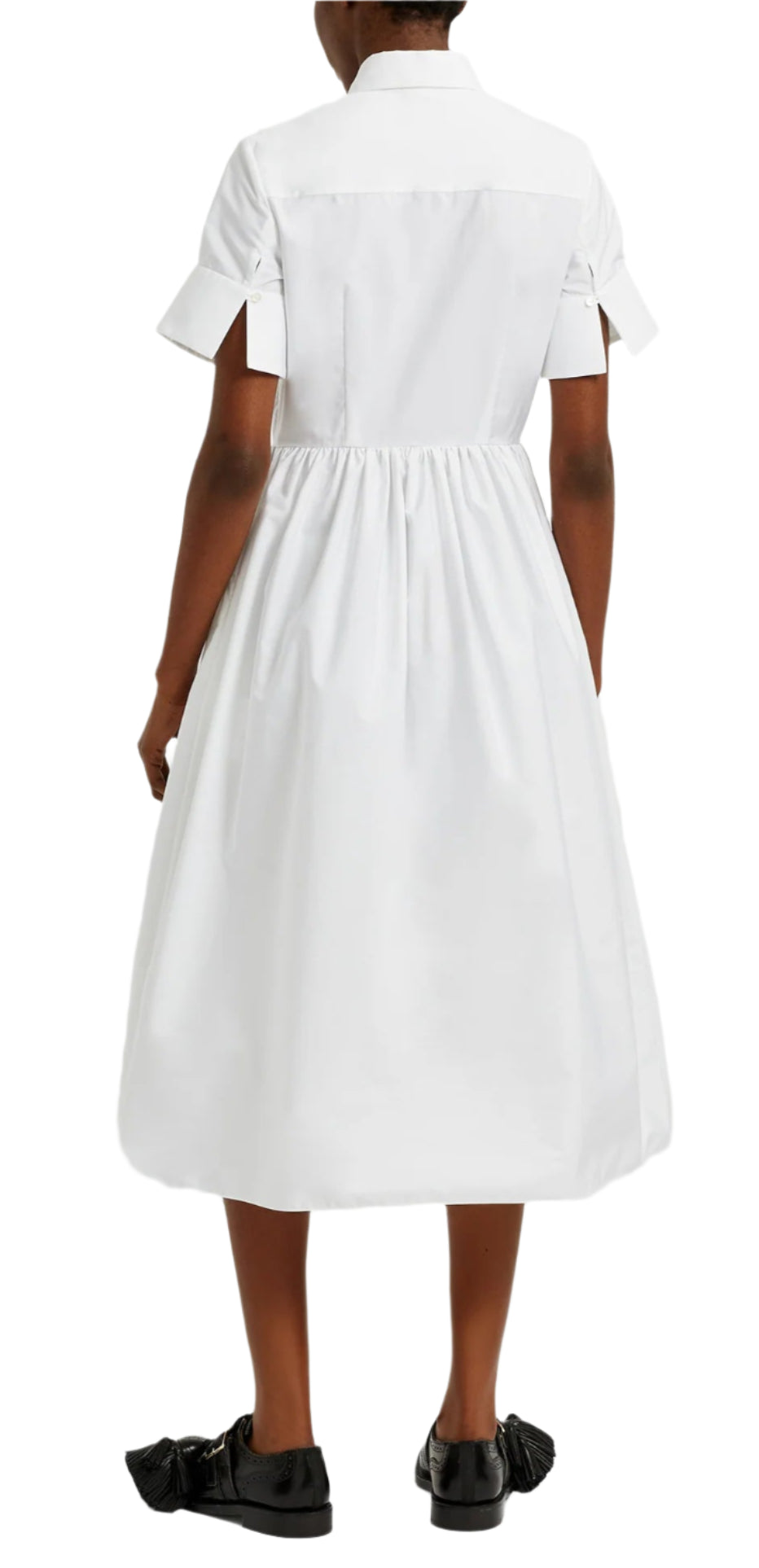 A person in Erdem's Short Sleeve Embroidered Shirt Dress, featuring an A-line silhouette and gathered waist, paired with black shoes, stands gracefully against a plain background.