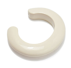 The Lizzie Fortunato Ridge Cuff, a glossy off-white resin bracelet with a thick, circular horseshoe shape and open gap, is displayed on a white background.
