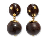 The Lizzie Fortunato Nopales Earrings are lightweight earrings featuring dark brown wood beads with gold-plated brass accents, gold-dotted ovals on top, and round beads below capped in gold.