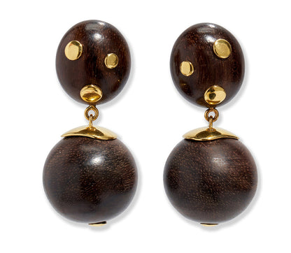 The Lizzie Fortunato Nopales Earrings are lightweight earrings featuring dark brown wood beads with gold-plated brass accents, gold-dotted ovals on top, and round beads below capped in gold.