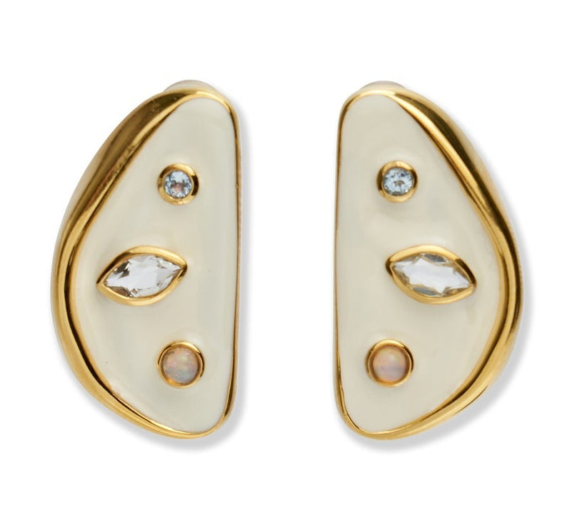 The Isola Stud Earrings by Lizzie Fortunato are asymmetrical gold-plated brass earrings with cream enamel, featuring round, marquise, and opal-like stones, shown against a white background.