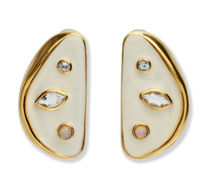 The Isola Stud Earrings by Lizzie Fortunato are asymmetrical gold-plated brass earrings with cream enamel, featuring round, marquise, and opal-like stones, shown against a white background.