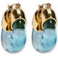 The Organic Gold Hoops by Lizzie Fortunato feature gold-toned metal tops and curved, translucent blue resin drops.