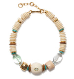 The Coquina Necklace by Lizzie Fortunato features cream, gold, turquoise, and clear beads in assorted shapes, recycled bone accents, a gold clasp, and an adjustable chain.