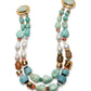 The Ariel Necklace by Lizzie Fortunato is a turquoise double-strand statement piece with freshwater pearls, gold-toned beads, brown accents, and round clasps at each end.