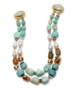 The Ariel Necklace by Lizzie Fortunato is a turquoise double-strand statement piece with freshwater pearls, gold-toned beads, brown accents, and round clasps at each end.
