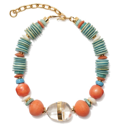 The Neptune Collar by Lizzie Fortunato is a stunning statement necklace with turquoise and coral discs, round peach beads, a clear oval bead with gold bands, and a gold chain clasp—perfect for any occasion.