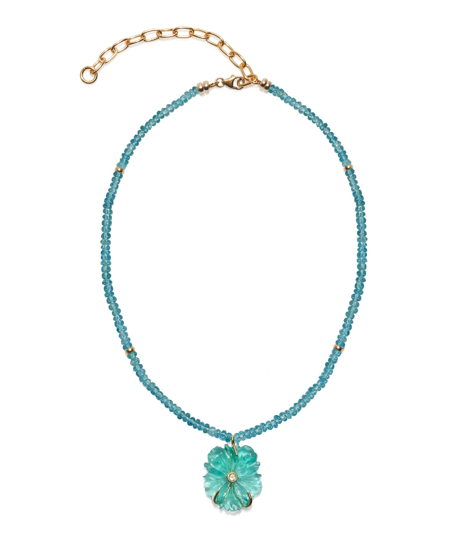 The Lizzie Fortunato New Bloom Necklace features vibrant beaded turquoise, a gold chain extender, and a carved turquoise flower pendant with a central gemstone, evoking the lively hues of an apatite beaded necklace.