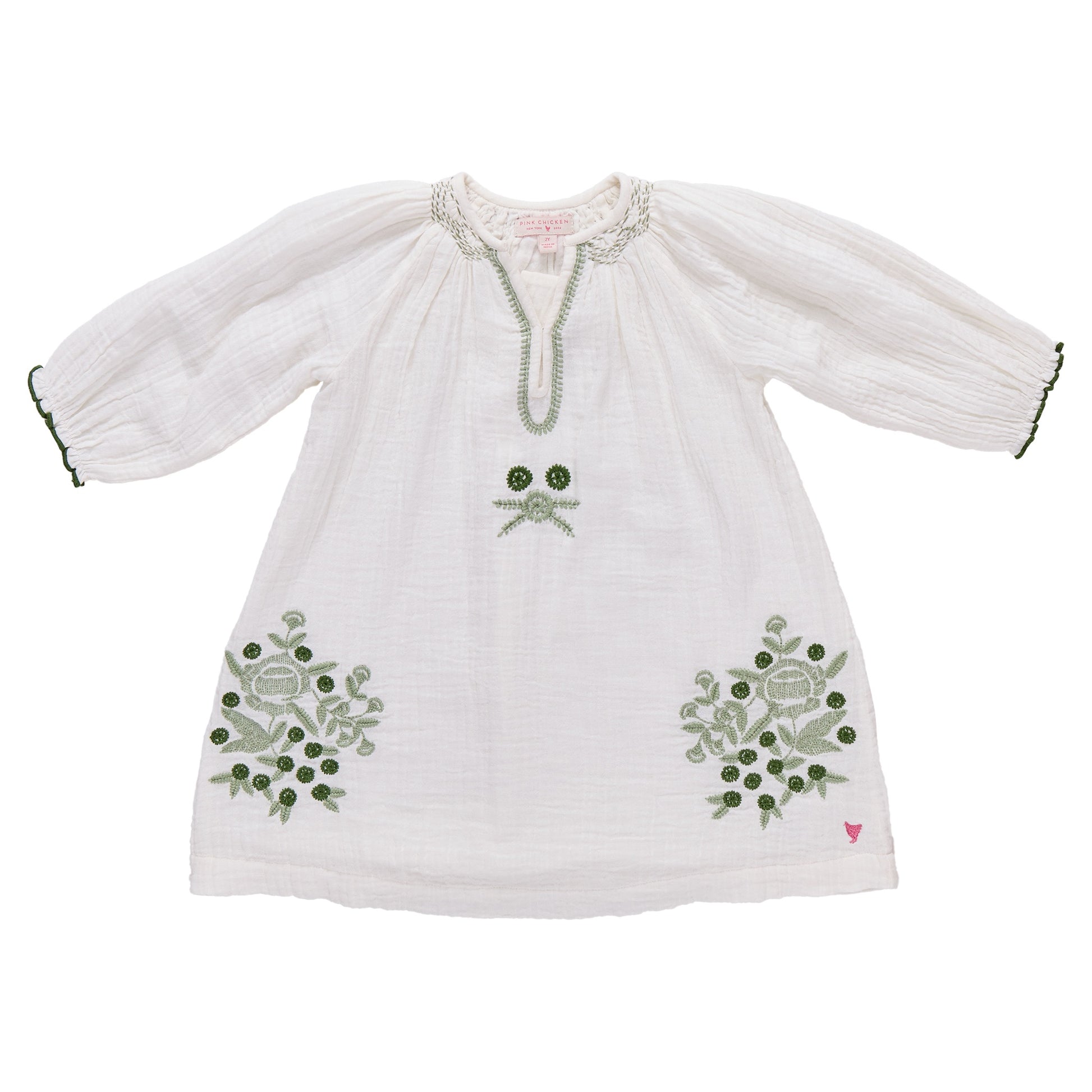 The Girls' Ava Dress by Pink Chicken is a white cotton gauze long-sleeve dress with green embroidered florals on the front and sleeves, finished with a round neckline and keyhole opening.