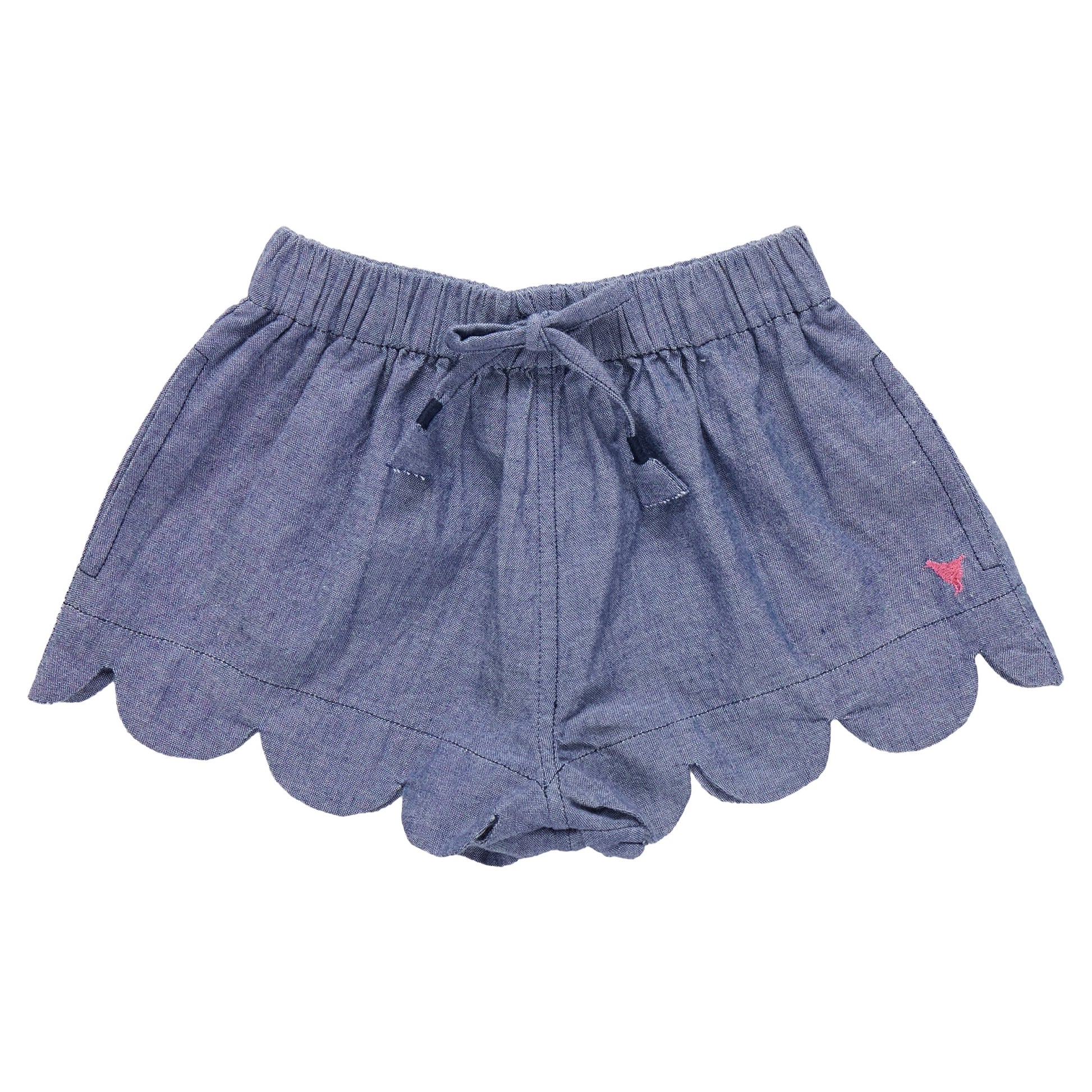 The Pink Chicken Girls' Scallop Short features a blue chambray fabric, scalloped hem, elastic waistband, front drawstring, and a pink embroidered logo—perfect for summer days.