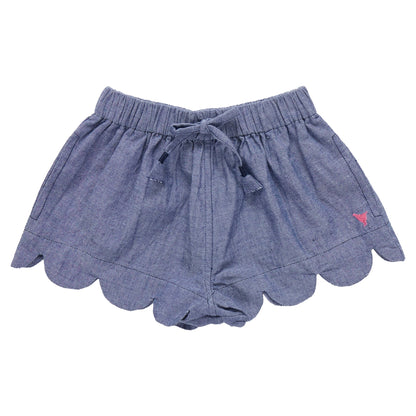 The Pink Chicken Girls' Scallop Short features a blue chambray fabric, scalloped hem, elastic waistband, front drawstring, and a pink embroidered logo—perfect for summer days.