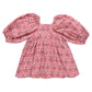 The Girls' Mary Barrett Dress by Pink Chicken features a pink strawflower floral pattern, puffed long sleeves, and a square neckline—laid flat on a white background, it’s a twirl-ready dress perfect for any occasion.