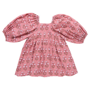 The Girls' Mary Barrett Dress by Pink Chicken features a pink strawflower floral pattern, puffed long sleeves, and a square neckline—laid flat on a white background, it’s a twirl-ready dress perfect for any occasion.
