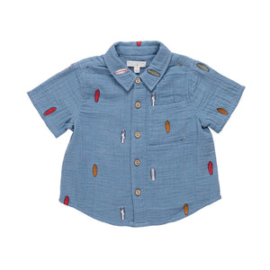 The Baby Boys’ Jack Shirt by Pink Chicken is a light blue, tailored cotton button-up with short sleeves, colorful surfboard prints, and a chest pocket. Shown on a white background, this lightweight and breathable shirt is perfect for baby boys.