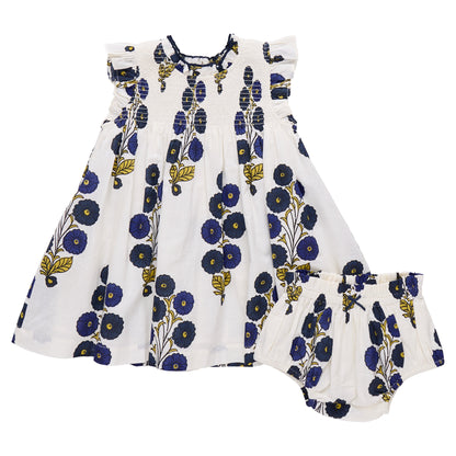 The Pink Chicken Baby Girls' Stevie Dress features short ruffled sleeves and comes with matching bloomers, both in a charming Navy Buttercup Floral print of blue and yellow.