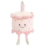 Celebrate with Mon Ami’s Birthday Cake - Pink, a plush shaped like a smiling pink cake, topped with a pink striped candle and featuring pink striped legs with silver shoes. This cuddly treat makes every birthday extra sweet!.