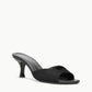 The Brigitte Satin Mule by Staud is a black open-toe mule sandal with a mid stiletto heel and minimalist design, ideal for versatile styling.