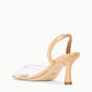 The Staud Brigitte Heel is a beige nappa leather sandal with a transparent front strap, open back, and curved heel, displayed on a plain white background.