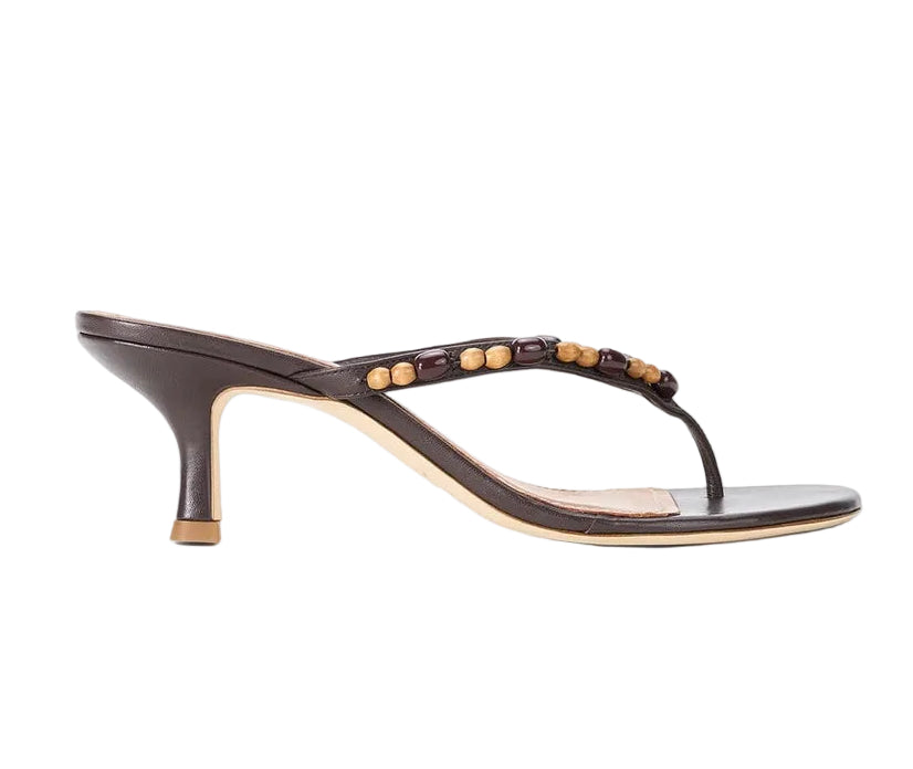 The Staud Freja Thong Kitten Heel sandal features a thong-style design with beaded strap embellishments, shown here in a side profile view.