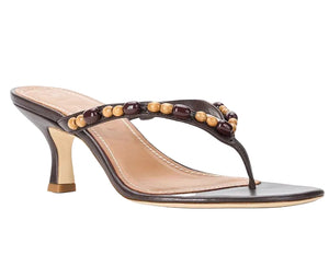 The Staud Freja Thong Kitten Heel showcases a black sole, open toe, and thong strap detailed with alternating brown and beige beads, finished with a comfy kitten heel.