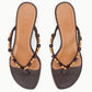 A pair of Staud Freja Thong Kitten Heel sandals in brown leather with tan insoles and decorative wooden beads on the straps, shown from above.