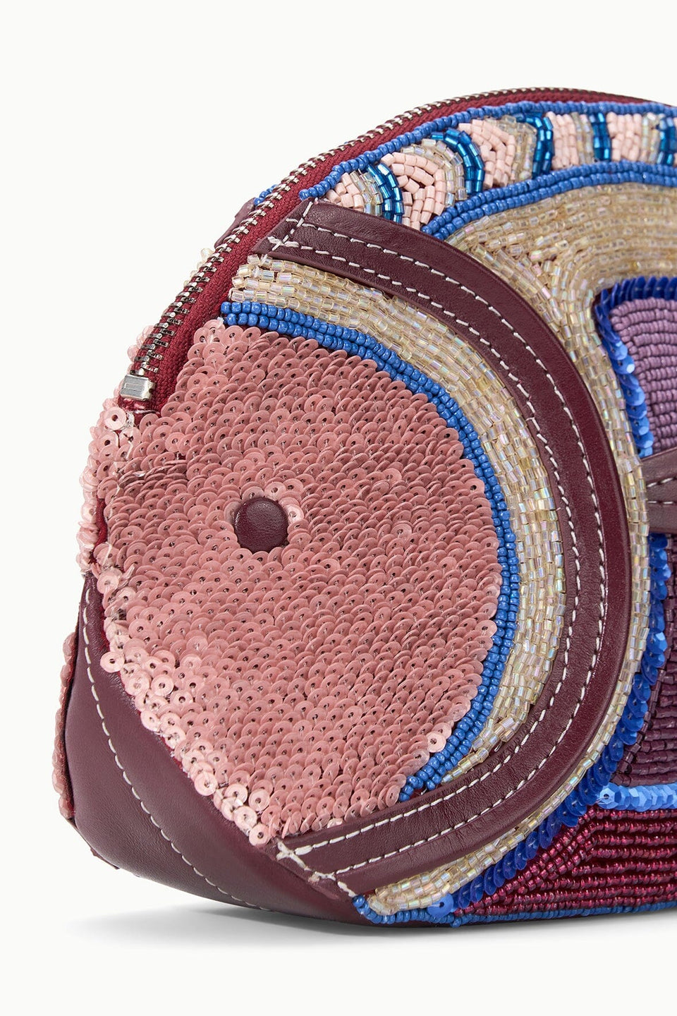 Close-up of the Staud Pesce Clutch, a maroon and pink sequin-embellished bag with bead detailing and zip closure, displayed against a white background.