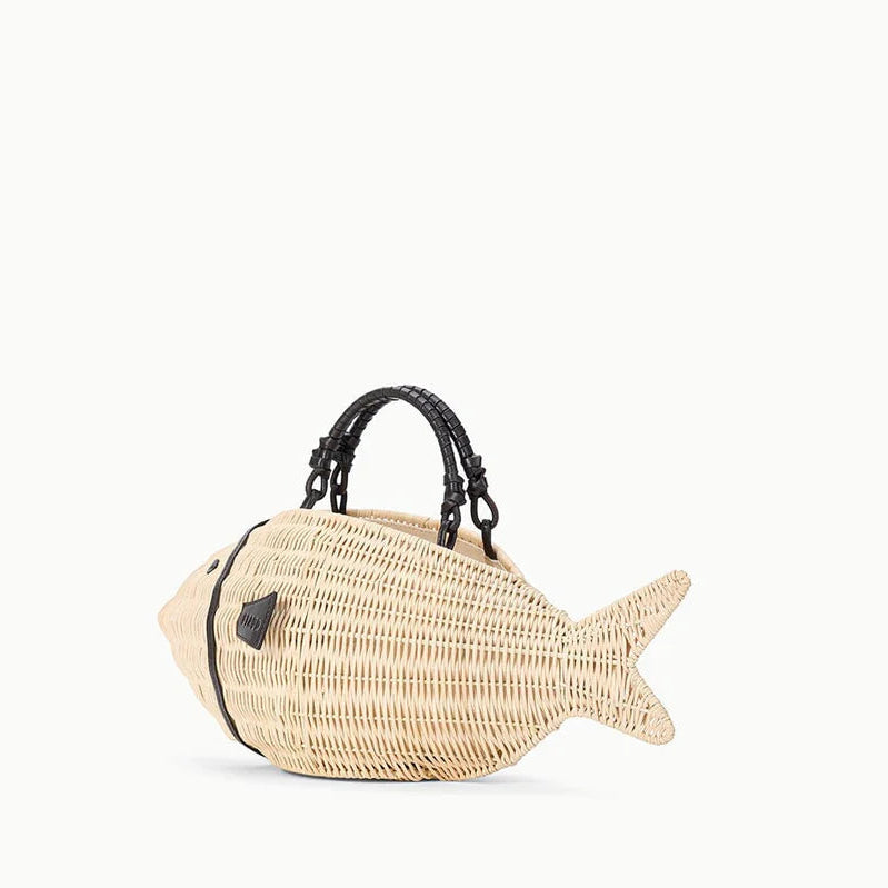 The Staud Cleo Fish Bag, shaped like a fish with a leather-wrapped handle and black accent near the opening, is displayed against a plain white background.
