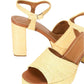 The Staud Jodie Platform Heel is a pair of beige sandals with chunky block heels, ankle straps, open toes, and a woven texture.