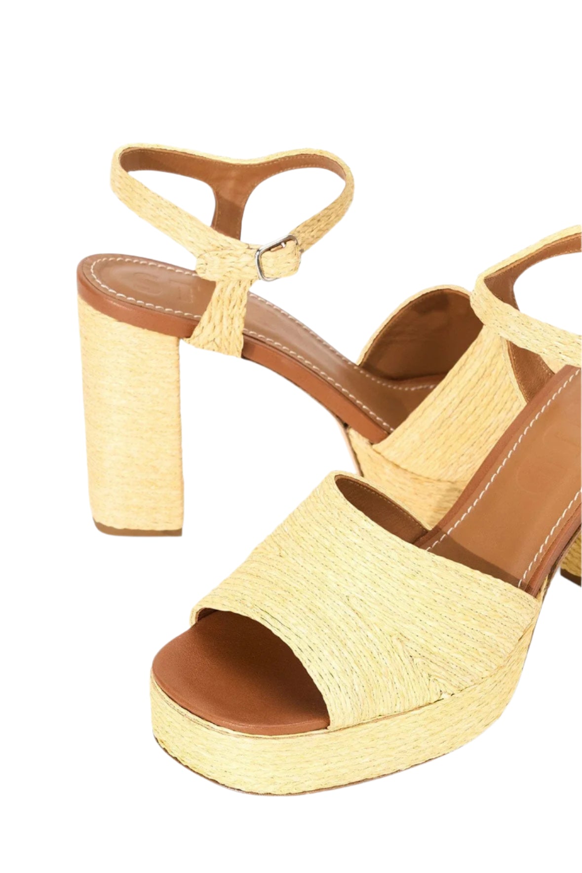 The Staud Jodie Platform Heel is a pair of beige sandals with chunky block heels, ankle straps, open toes, and a woven texture.