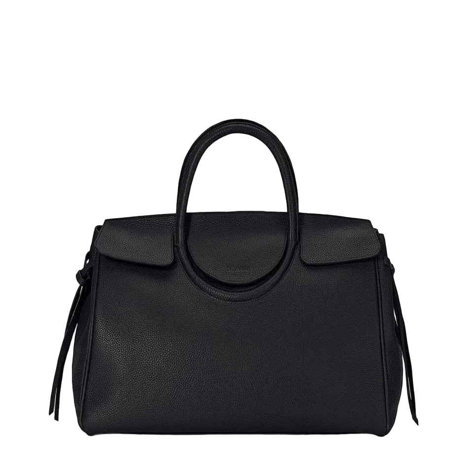The Maude Carryall by Staud is a black pebbled leather bag featuring rounded handles, a flap closure, and minimal detailing, displayed against a white background.