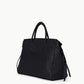The Staud Maude Carryall is a black pebbled leather tote bag featuring double handles and a structured silhouette, shown against a plain white background. This oversized bag blends timeless style with everyday practicality.