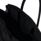Close-up of the Staud Maude Carryall—a black pebbled leather tote with handles—highlighting its spacious interior and textured material.