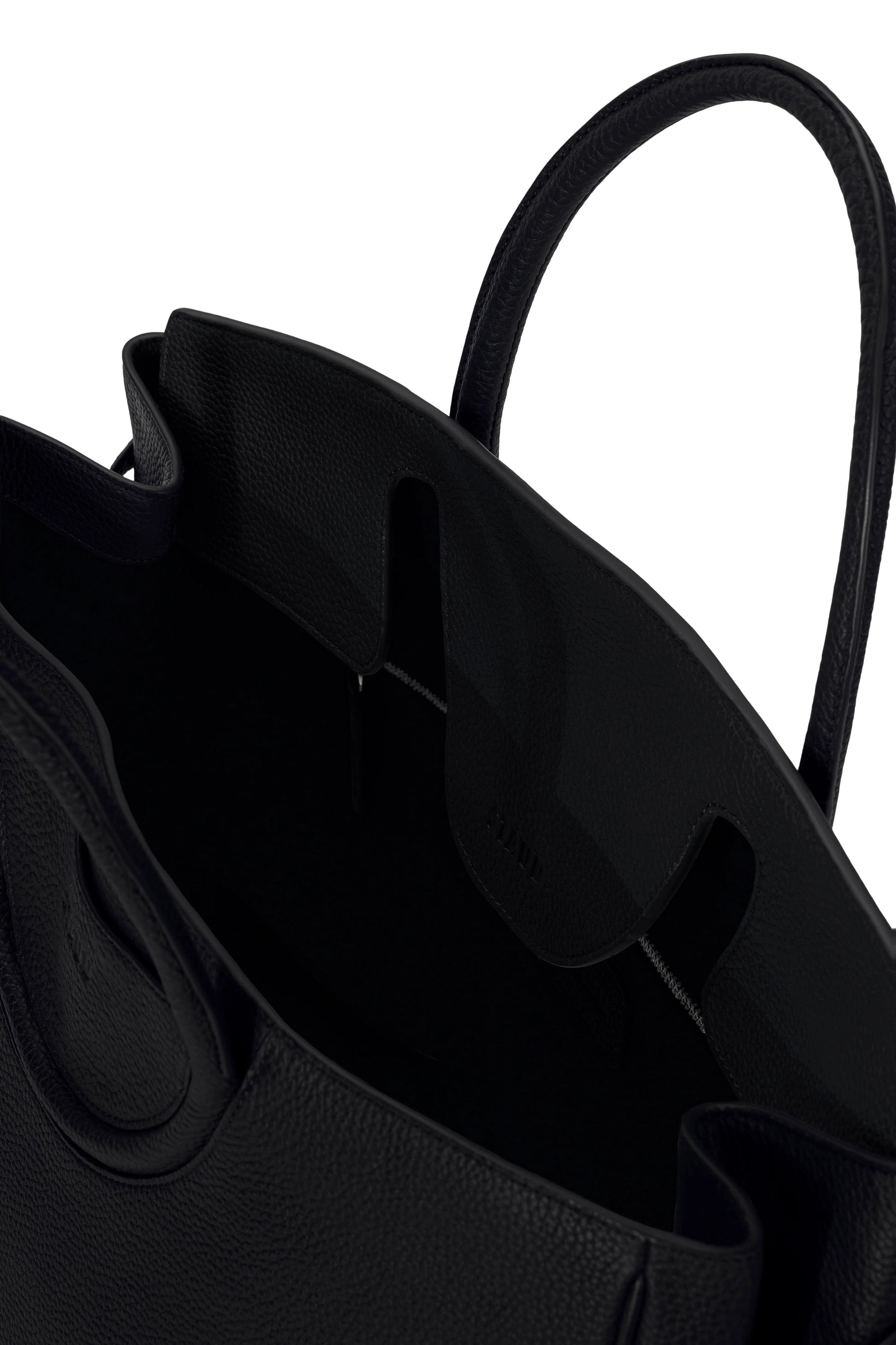 Close-up of the Staud Maude Carryall—a black pebbled leather tote with handles—highlighting its spacious interior and textured material.