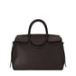 The Staud Maude Carryall is a dark brown pebbled leather handbag featuring two handles, a flap closure, and a structured rectangular shape, shown against a white background.