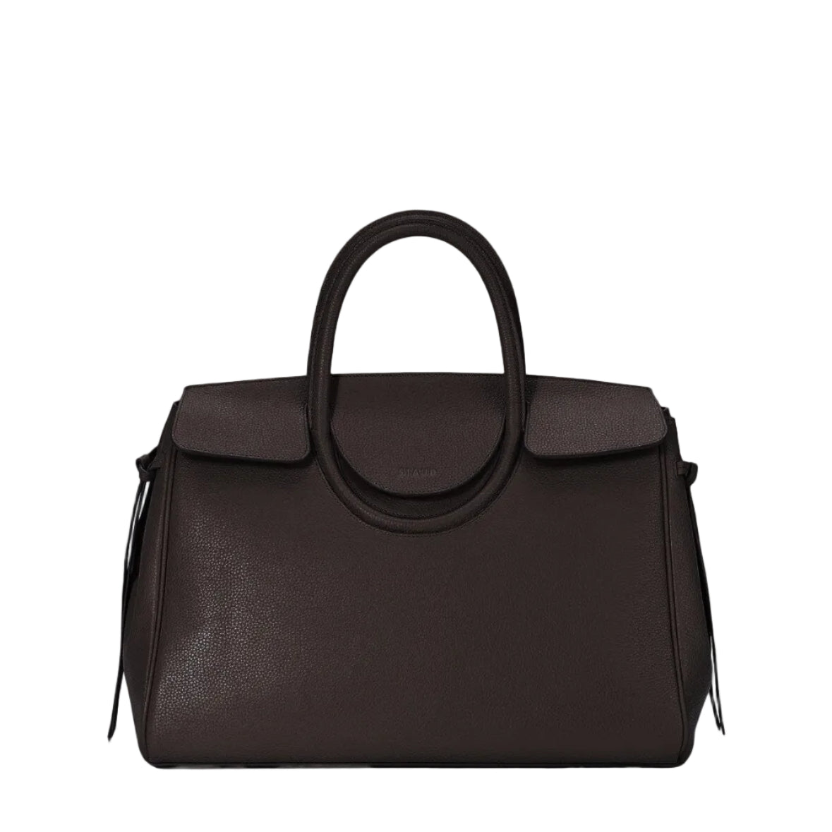 The Staud Maude Carryall is a dark brown pebbled leather handbag featuring two handles, a flap closure, and a structured rectangular shape, shown against a white background.
