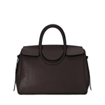 The Staud Maude Carryall is a dark brown pebbled leather handbag featuring a structured shape, top handle, flap closure, and minimal front branding.